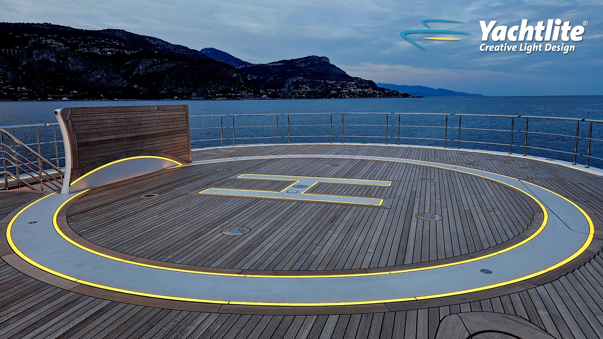 Superyacht helipad deck featuring Yachtlite FloorLite integrated warm white LED lighting embedded into the teak flooring.