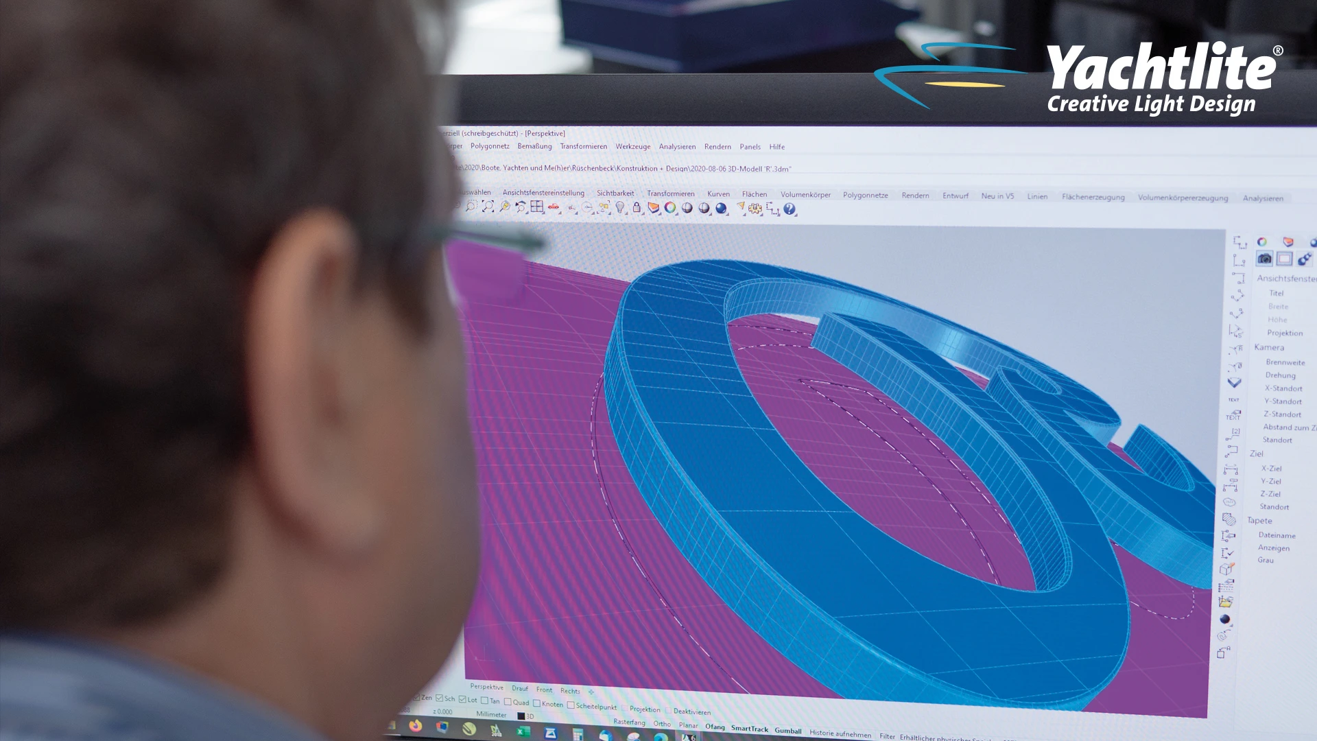 A person viewing a 3D computer model of a custom yacht sign during the design and manufacturing process, with Yachtlite branding visible on the screen.